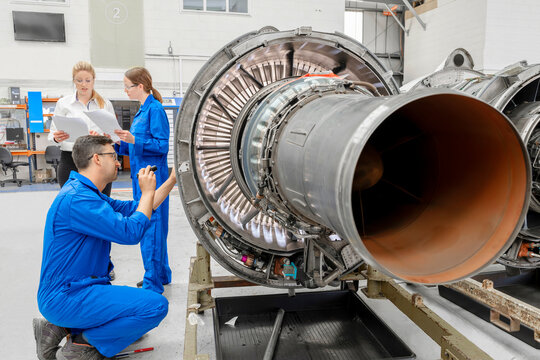 Man working on airplane engine