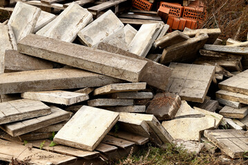 Construction waste. A pile of construction waste. Building rubble and stones. Abandoned garbage, junk, garbage piled up near the building. Street scene. Recycling industry. Ecology. Not Ecology.