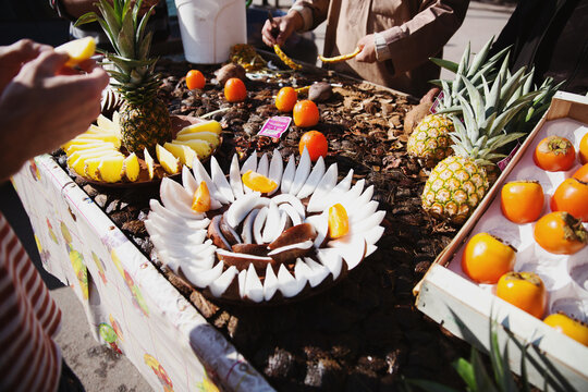 Coconut and pineapple displays at fruit stand