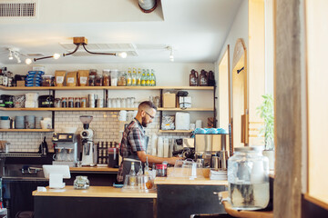 Man making coffee in cafe