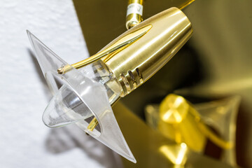Modern gold and plastic electric light fitting