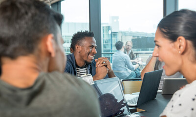 Colleagues using laptops during meeting