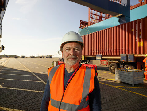 Dock worker by cargo container at Port of Felixstowe, England
