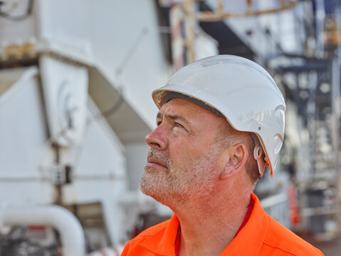 Dock worker with hardhat looking up