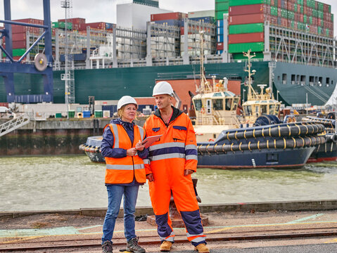 Dock workers with digital tablet at Port of Felixstowe, England