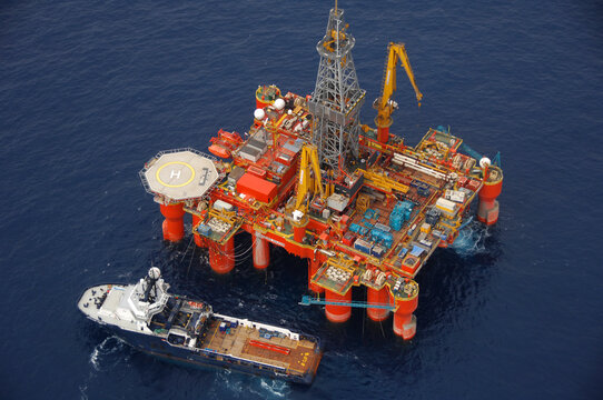 Aerial view of oil rig and ship on sea