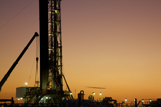View of drilling rig at sunset