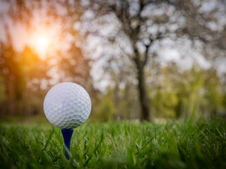 Golf ball  in beautiful golf course at sunset background