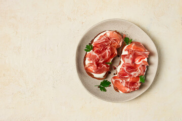 sandwich with cream cheese and prosciutto, on black grain bread, breakfast, homemade,