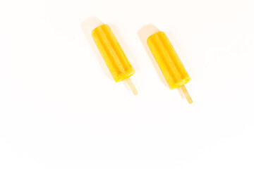 Mango orange ice lollies summer flat lay concept with copy space on light white background