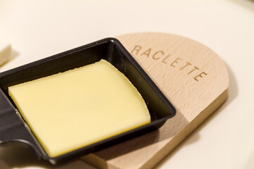 Slice of raclette cheese in a pan