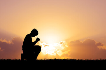 Fototapeta na wymiar A lonely and desperate man praying to God.