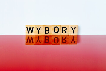 Polish white and red colors and the word, WYBORY, in Polish, meaning parliamentary elections, The concept of elections in Poland in October 2023