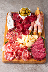 Charcuterie board. Antipasti appetizers of meat and cheese platter with salami, prosciutto crudo or jamon and olives