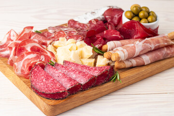 Charcuterie board. Antipasti appetizers of meat and cheese platter with salami, prosciutto crudo or jamon and olives