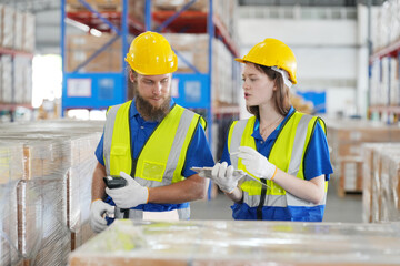 Warehouse Industrial supply chain and Logistics Companies inside. Warehouse workers checking the inventory. Products on inventory shelves storage. Worker Doing Inventory in Warehouse.