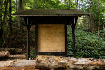 empty information sign in a wooded forest.