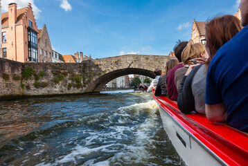 Tourists on a sight seeing boat trip in Bruges Belgium on the Brugge Zeebrugge Canal - 633099923