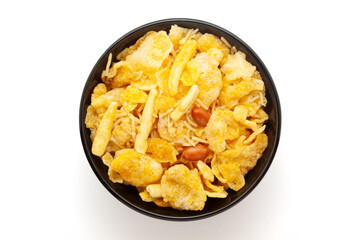 Close-up of Cornflakes Mixture Indian namkeen (snacks) on a ceramic black bowl. Isolated on white background. Top view