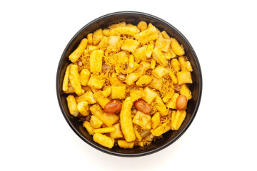 Close-up of Gadbad Indian namkeen (snacks) on a ceramic black bowl. Isolated on white background. Top view