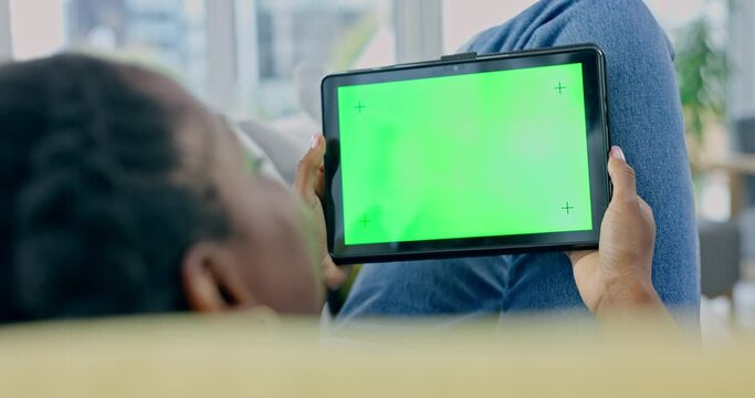 Person, tablet and green mockup in home to watch movies, subscription blog and streaming multimedia show from the back. Closeup, digital screen and advertising space, tracking markers and app on sofa