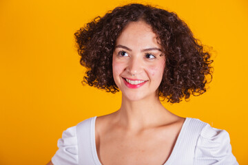 Caucasian model in white shirt smiling, close-up shot.