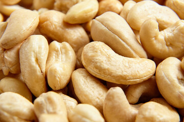 Cashew nut heap as food texture background, macro shot.