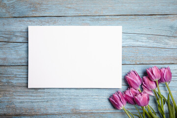 Blank white canvas mockup on blue wood background. Gallery-style wall art, white canvas