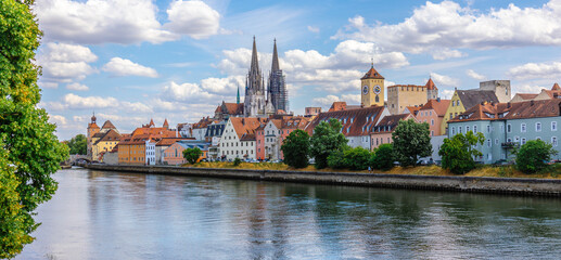Panoramic view of Regensburg. Stone Bridge with Danube River with reflections of houses in water....