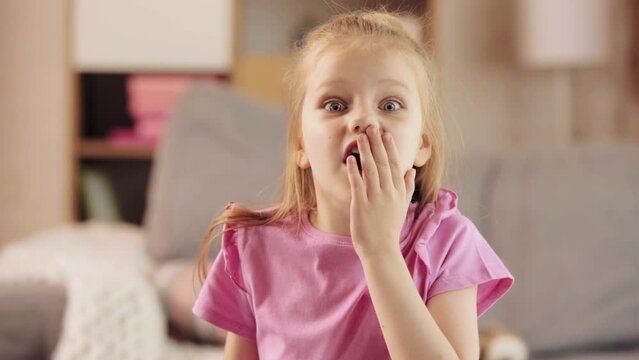 Little emotional girl, child showing expression of shock and surprise. Emotive kid, expressing feelings. Concept of family, childhood, happiness, love and care