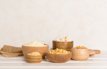 Maize products with fresh corn cobs on wooden table