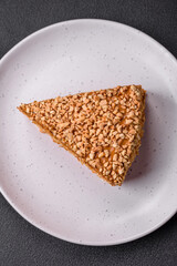 Delicious sweet puff waffle cake with cream and nuts cut into pieces