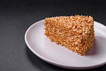 Delicious sweet puff waffle cake with cream and nuts cut into pieces