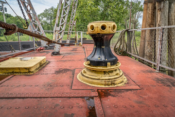 capstan and other gear on a deck of a vintage sidewheeler river dredge