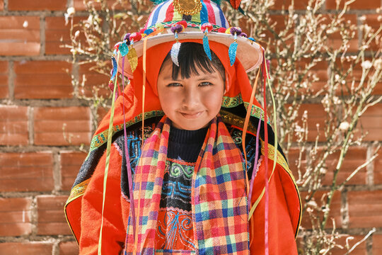 bolivian latin girl smiling with colorful tinku folkloric costume in the daytime