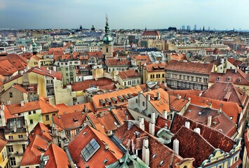 Naklejka na ściany i meble roofs of Praque with colorful tiled roofs are seen from the top of the church