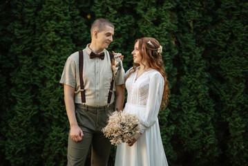 wedding walk of the bride and groom in a coniferous