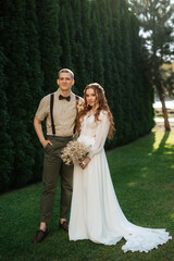 Fototapeta na wymiar wedding walk of the bride and groom in a coniferous