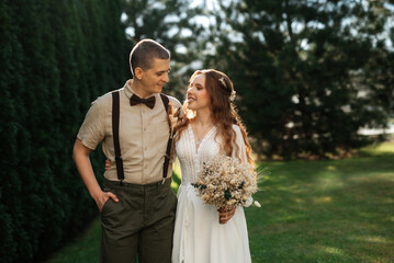 wedding walk of the bride and groom in a coniferous