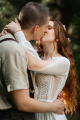 wedding walk of the bride and groom in a coniferous