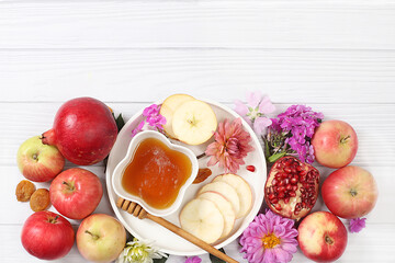 Rosh hashanah jewish holiday concept with apples, honey, pomegranate and dried apricots on bright white background, top view with place for your text, jewish new year and thanksgiving day