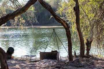 "The charm of outdoor life: Kitchen by the river and leafy trees"