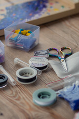 The tools of the master weaving from beads lies 