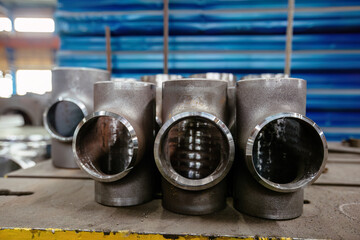 Batch of T-shape pipe parts in factory