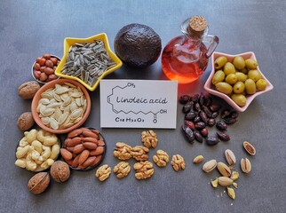Food high in linoleic acid with structural chemical formula of linoleic acid. Natural food sources of omega 6 and omega 3 essential fatty acids. Good fats - nuts, seeds, oils; concept of healthy diet. - obrazy, fototapety, plakaty
