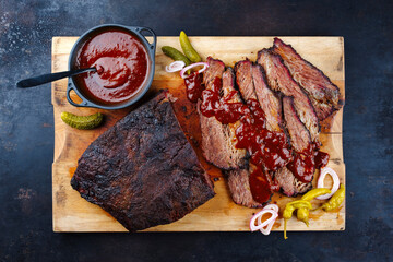 Traditional smoked wagyu beef brisket served with vegetable and spicy barbecue Louisiana sauce and...