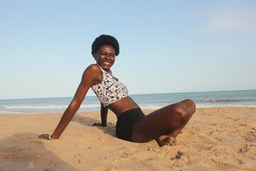Oceanic Zen: Serene African Woman in Yoga Pose by the Shore