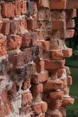 old bricks protruding from the corner of a damaged wall