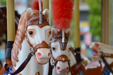 Fototapeta na wymiar Carousel horse at fair is vintage fun ride for children