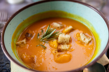 Pumpkin butternut squash soup with Rosemary and rustic croutons in a bowl at a restaurant in Rome Italy